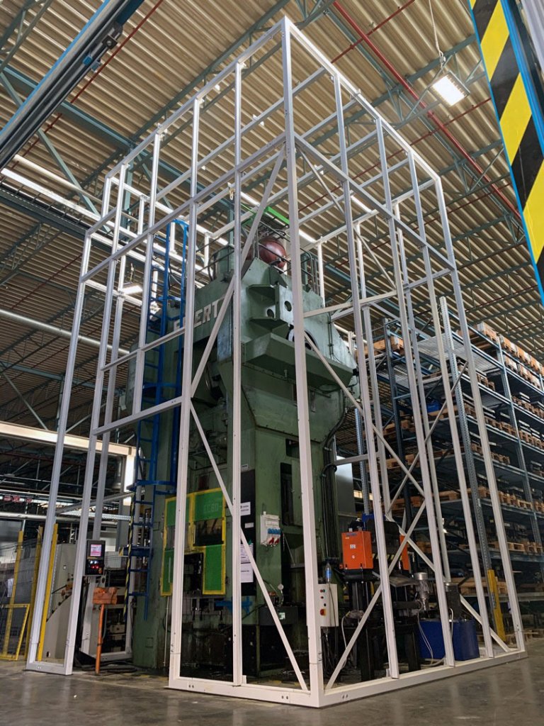 Soundproof enclosure for a large punch press within the Miba factory in Slovakia